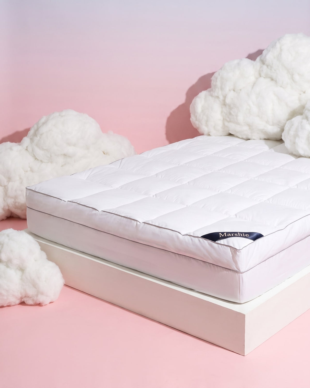 The Marshie Topper between soft white clouds